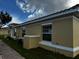 Tan house with a red tile roof, white trim, and a brick walkway at 1652 Cumin Dr, Poinciana, FL 34759