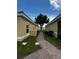 Brick walkway between two buildings, showing AC units and landscaping at 1652 Cumin Dr, Poinciana, FL 34759