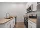 Modern kitchen with stainless steel appliances and granite countertops at 1652 Cumin Dr, Poinciana, FL 34759