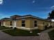 Side view of a single-Gathering home with yellow exterior and tile roof at 1652 Cumin Dr, Poinciana, FL 34759