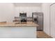 Modern kitchen with white cabinets, granite counters, and stainless steel appliances at 1652 Cumin Dr, Poinciana, FL 34759