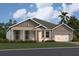 Single-story home with gray siding and two-car garage at 3287 Roseville Dr, Apopka, FL 32712