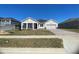 Single-story home with gray siding and two-car garage at 3287 Roseville Dr, Apopka, FL 32712