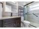 Clean bathroom with dark vanity, shower stall and a granite countertop at 926 Everett St, Lake Alfred, FL 33850