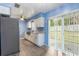 Updated kitchen with white cabinets, stainless steel appliances and sliding glass doors to backyard at 926 Everett St, Lake Alfred, FL 33850