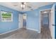 Light blue bedroom with wood-look flooring and access to bathroom at 926 Everett St, Lake Alfred, FL 33850