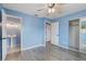 Light blue bedroom with wood-look floors and en-suite bathroom at 926 Everett St, Lake Alfred, FL 33850