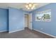 Light blue bedroom with grey carpet and a large closet at 926 Everett St, Lake Alfred, FL 33850