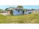 Home's backyard with grassy lawn and fire pit at 926 Everett St, Lake Alfred, FL 33850