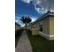 Brick walkway next to tan house exteriors with white trim and red tile roofs at 1648 Cumin Dr, Kissimmee, FL 34759