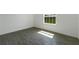 Bright bedroom with grey tile floor and a view of the backyard at 1648 Cumin Dr, Kissimmee, FL 34759