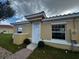 Tan exterior house with white trim, red tile roof, and brick walkway at 1648 Cumin Dr, Kissimmee, FL 34759
