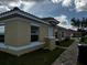 Tan house exterior with white trim, red tile roof, and brick walkway at 1648 Cumin Dr, Kissimmee, FL 34759