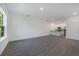 Open living room with gray tile floors and white walls at 1648 Cumin Dr, Kissimmee, FL 34759