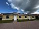 Three-unit building with red tile roofs, yellow siding, and brick driveways at 1648 Cumin Dr, Kissimmee, FL 34759