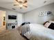 Bright bedroom featuring a queen-size bed, TV, and built-in shelving at 24341 Milford Dr, Eustis, FL 32736