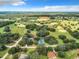 Aerial view of property with expansive land, featuring a tennis court at 24341 Milford Dr, Eustis, FL 32736
