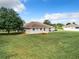 Large backyard with grassy area and a home at 24341 Milford Dr, Eustis, FL 32736