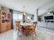 Bright dining room with a wooden table and chairs, adjacent to the kitchen at 24341 Milford Dr, Eustis, FL 32736