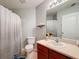 Clean bathroom with a vanity, toilet, shower, and decorative accents at 24341 Milford Dr, Eustis, FL 32736