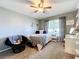 Cozy bedroom with a comfortable bed, ceiling fan, and ample natural light at 24341 Milford Dr, Eustis, FL 32736