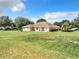 Spacious backyard with a large grassy area, perfect for outdoor activities at 24341 Milford Dr, Eustis, FL 32736