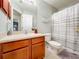 Neat bathroom with shower, toilet and wooden vanity at 24341 Milford Dr, Eustis, FL 32736