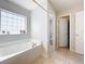 Bathroom with a soaking tub, shower, and a window at 24341 Milford Dr, Eustis, FL 32736