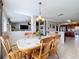 Charming dining area with a wooden table and chairs, offering views of the living area at 24341 Milford Dr, Eustis, FL 32736