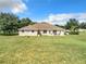 Spacious backyard with large grassy area and home at 24341 Milford Dr, Eustis, FL 32736