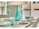 Dining room table set for a meal with teal accents at 5116 Killarney Way, Kissimmee, FL 34746