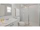 Bathroom with shower, vanity, and white cabinets at 5116 Killarney Way, Kissimmee, FL 34746