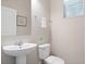 Clean and modern half bathroom with pedestal sink and toilet at 5116 Killarney Way, Kissimmee, FL 34746