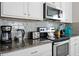 Modern kitchen with stainless steel appliances and granite countertops at 5116 Killarney Way, Kissimmee, FL 34746