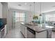 Modern kitchen with island, stainless steel appliances, and granite countertops at 5116 Killarney Way, Kissimmee, FL 34746