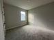 Well-lit bedroom featuring neutral walls and carpet at 3255 Roseville Dr, Apopka, FL 32712