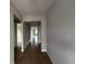 Bright hallway with wood-look floors and views into other rooms at 3255 Roseville Dr, Apopka, FL 32712