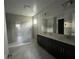 Double vanity bathroom with a large mirror and walk-in shower at 3263 Roseville Dr, Apopka, FL 32712