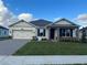One-story house with a two-car garage and landscaped lawn at 3263 Roseville Dr, Apopka, FL 32712