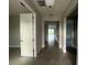 Bright hallway with neutral walls and tiled flooring at 3263 Roseville Dr, Apopka, FL 32712
