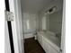 Bathroom with double vanity, tub, and tile flooring at 3279 Roseville Dr, Apopka, FL 32712
