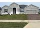 Two-story house with gray siding, brick driveway, and landscaping at 3279 Roseville Dr, Apopka, FL 32712