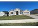 Two-story home with gray siding and a three-car garage at 3279 Roseville Dr, Apopka, FL 32712