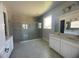 Bathroom with a large walk-in shower, double vanity, and grey tile at 3279 Roseville Dr, Apopka, FL 32712