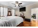 Large bedroom with hardwood floors, a king-size bed, and a flat-screen TV at 120 Circle Hill Rd, Sanford, FL 32773