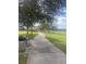 Paved pathway winds through a lush park with benches and gazebos at 8272 Le Mesa St, Orlando, FL 32827