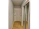 Hallway with tile floors and mirrored closet doors at 8272 Le Mesa St, Orlando, FL 32827