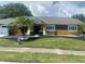 Charming yellow house with a well-maintained lawn at 8272 Le Mesa St, Orlando, FL 32827