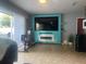 Living room with teal accent wall and exercise bike at 8272 Le Mesa St, Orlando, FL 32827