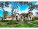 Two-story house with tile roof, manicured lawn, and lush landscaping at 11227 Macaw Ct, Windermere, FL 34786